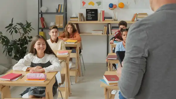 Pupils at their desks in a bright classroom
